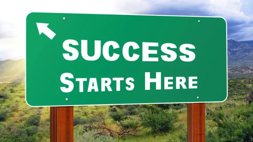 A green sign that says success starts here.